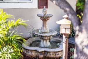 outside fountain and green palms at La Mesa facility